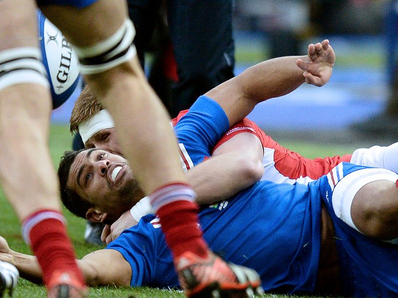 On the deck: France's right wing Wesley Fofana is tackled by Wales' lock Andrew Coombs