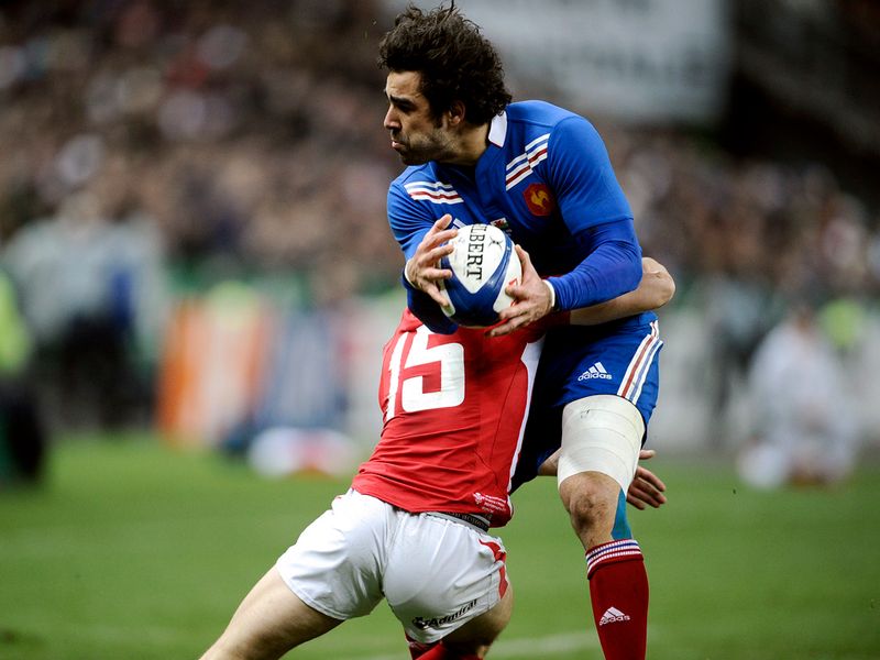 Crunching tackle: Yoann Huget is smashed into by Leigh Halfpenny