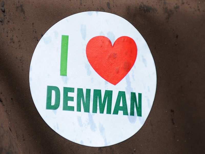 A fan wears an 'I Love Denman' sticker at Newbury