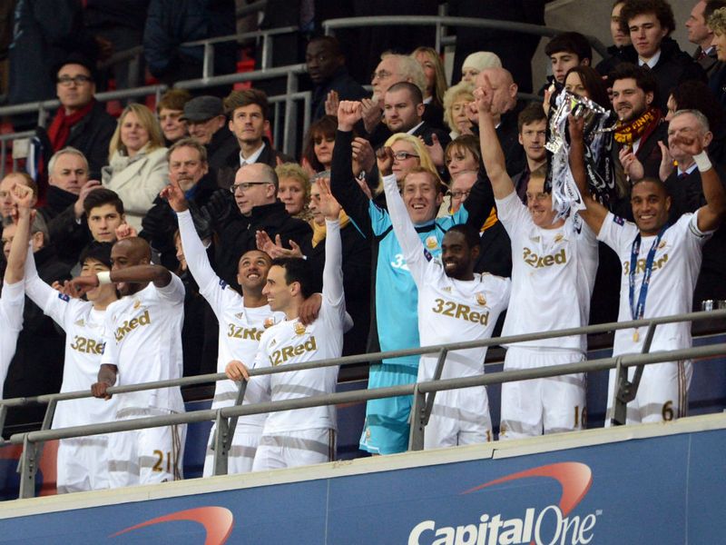 Swansea celebrate beating Bradford 5-0 by lifting the Capital One Cup at Wembley after the final whistle