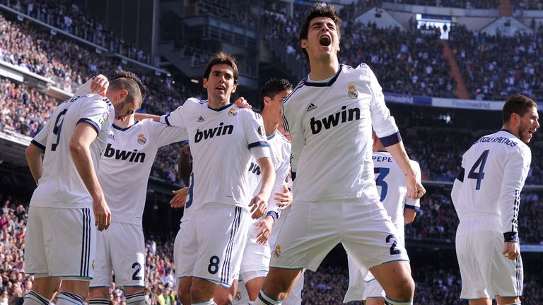 Karim Benzema is mobbed after scoring the opener in Saturday's El Clasico
