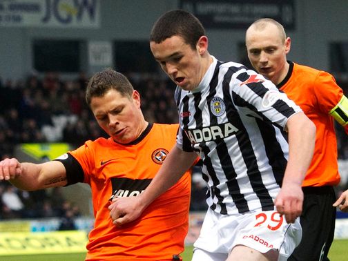 John Rankin battles for the ball with John McGinn