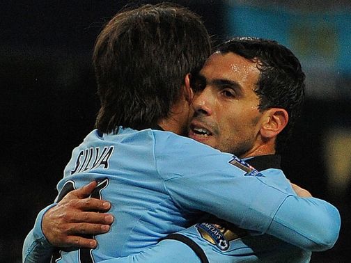 Hat-trick Carlos Tevez celebrates at the Etihad