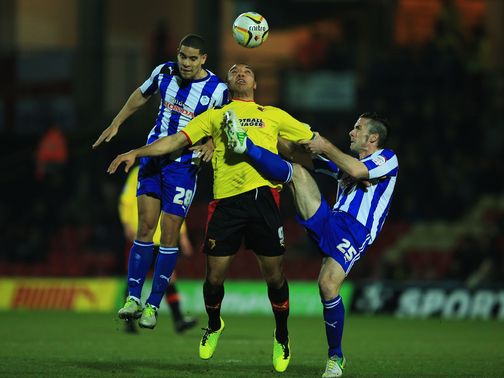 Deeney battles for the ball under pressure from Coke and Prutton