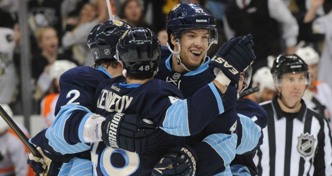 Tyler Kennedy (centre) is mobbed after his overtime winner