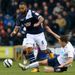 Jason Lowe slides in to make a tackle on Liam Trotter