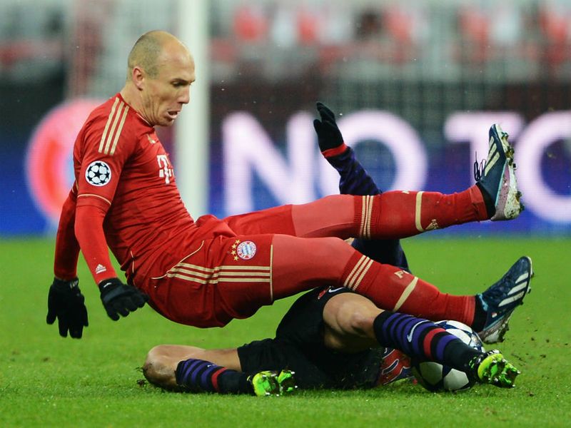 Bayern Munich winger Arjen Robben is dumped to the ground by a challenge from Arsenal full-back Kieran Gibbs