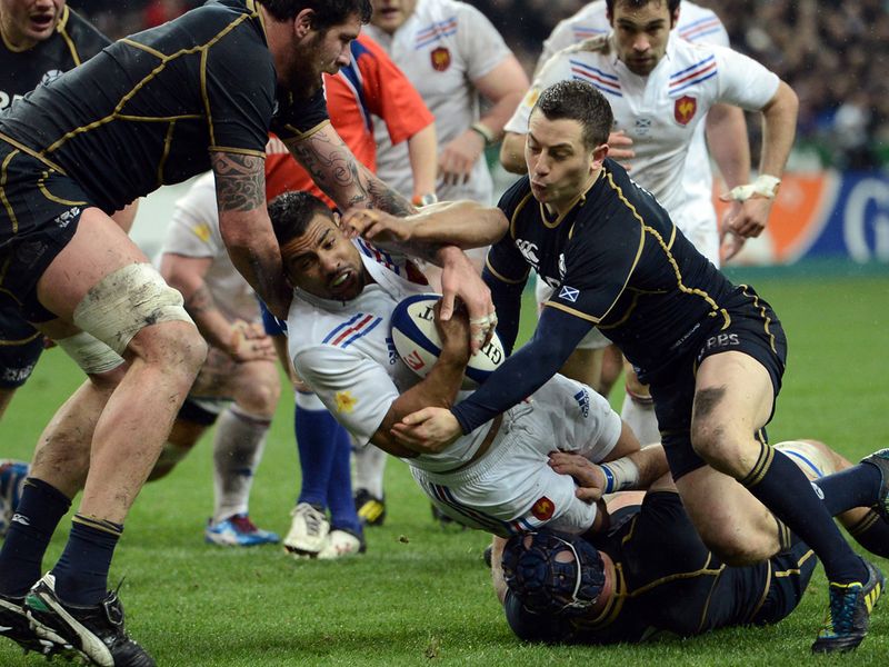 Brought down: Scotland smother Sebastien Vahaamahina