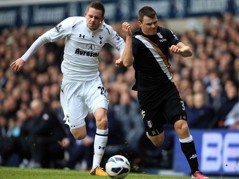 John Arne Riise holds off Gylfi Sigurdsson in the early stages between Tottenham and Fulham