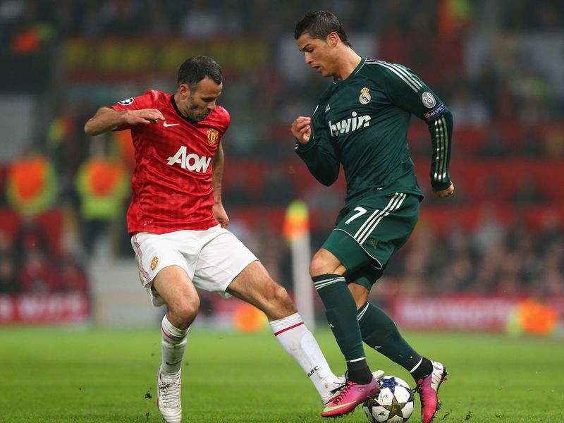 Ryan Giggs tackles Cristiano Ronaldo, with the Real Madrid superstar being kept quiet so far by the hosts.