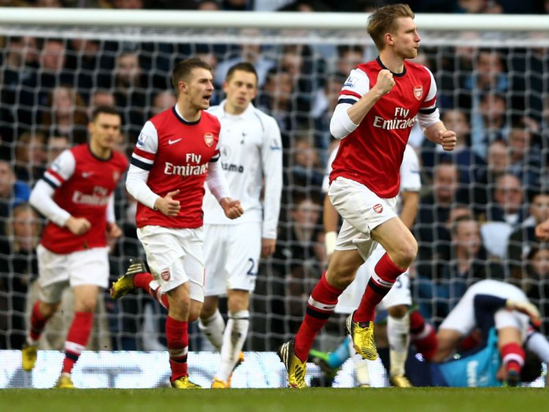 Defender Per Mertesacker runs away after his header deflects in for a goal to Arsenal
