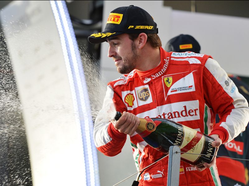 Fernando Alonso celebrates on the podium