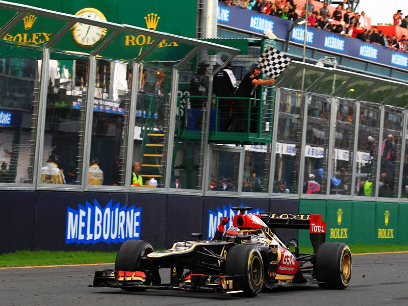 Kimi Raikkonen takes the chequered flag
