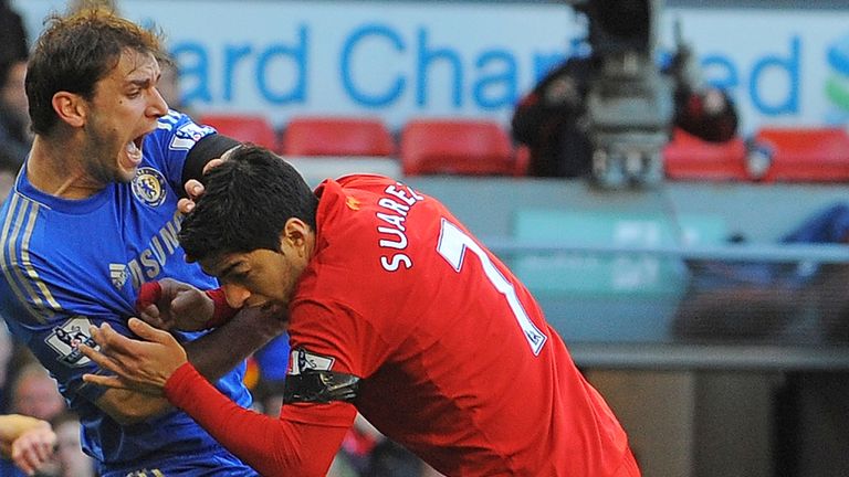 Luis Suarez attacks Branislav Ivanovic during Liverpool's 2-2 draw with Chelsea