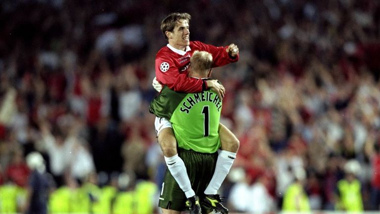 Phil Neville and Peter Schmeichel of Manchester United celebrate victory over Bayern Munich