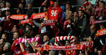 Liverpool supporters hold scarves and shirts during a memorial service on the 24th anniversary of the Hillsborough disaster