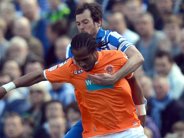 Nathan Delfouneso and Brighton's Will Buckley compete