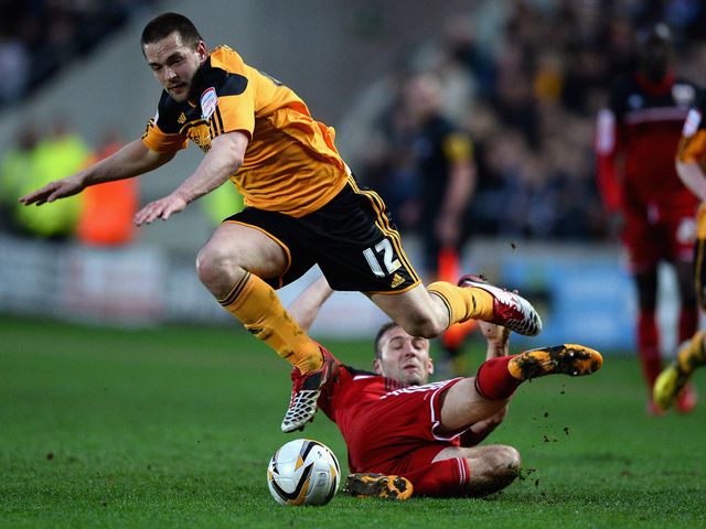 Hull's Matty Fryatt avoids Liam Kelly