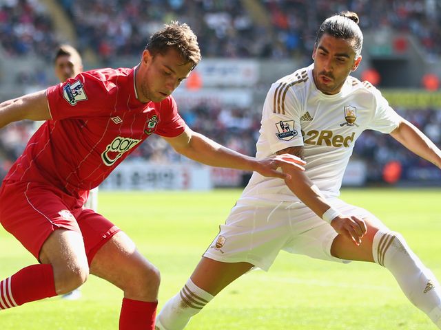 Chico Flores of Swansea tracks Southampton striker Jay Rodriguez.