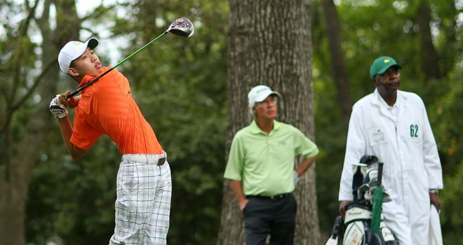 Ben Crenshaw looks on as Guan Tianlang drives off