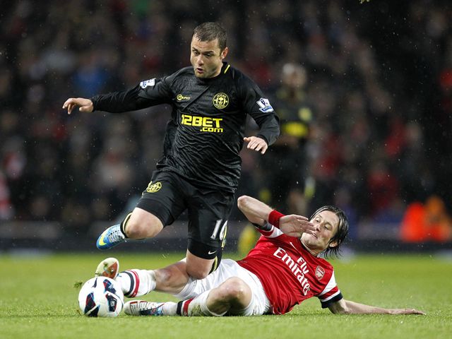 Tomas Rosicky challenges Shaun Maloney.