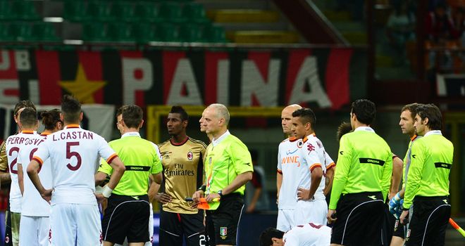Play is briefly suspended at the San Siro