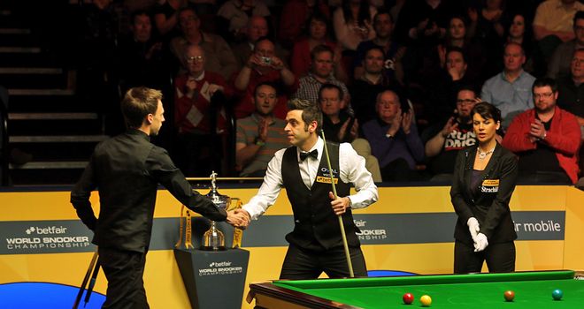 Ronnie O'Sullivan shakes hands with Judd Trump after completing a 17-11 victory