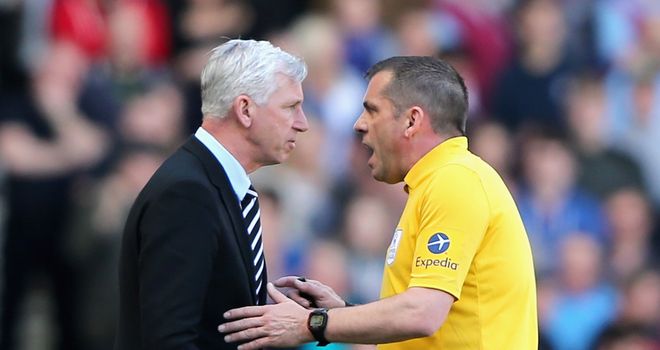 Newcastle manager Alan Pardew speaks to referee Phil Dowd during the Premier League match against West Ham United