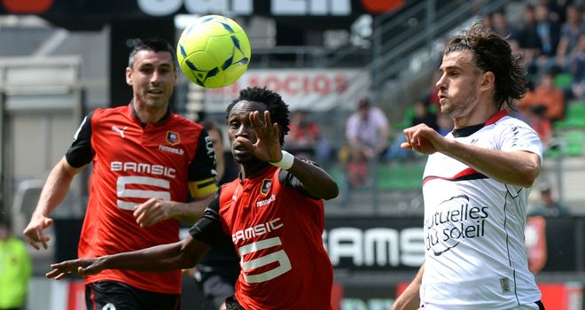 Jonathan Pitroipa vies for possession with Nemanja Pejcinovic