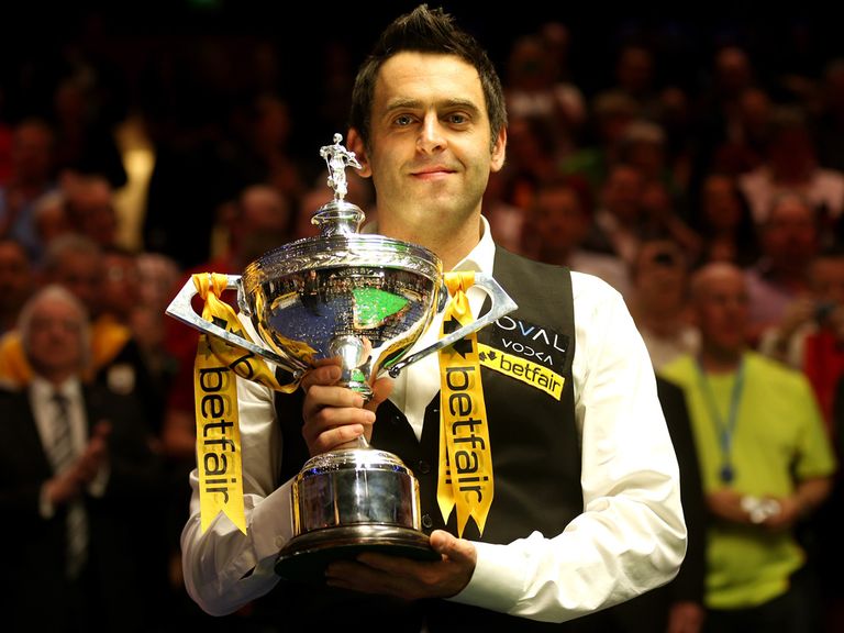 Ronnie O'Sullivan celebrates with the World Snooker Championship trophy.