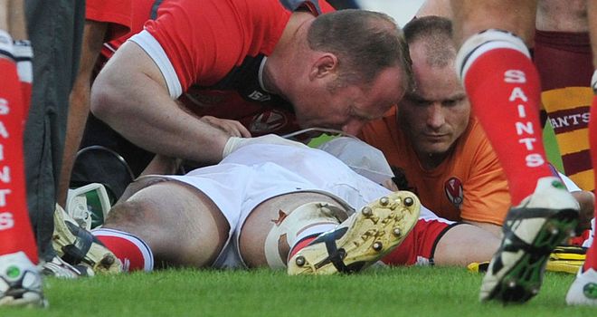 Ade Gardner lies injured on the turf at the John Smith's Stadium on Monday