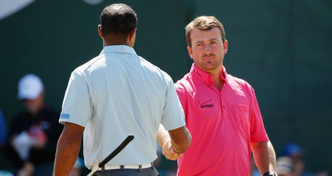 Graeme McDowell congratulates Tiger Woods at the end of the second round