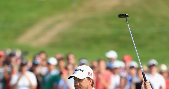 Graeme McDowell: Celebrates victory on the 18th green at Le Golf National