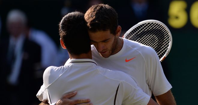 Novak Djokovic embraces beaten opponent Juan Martin del Potro after their thrilling semi-final
