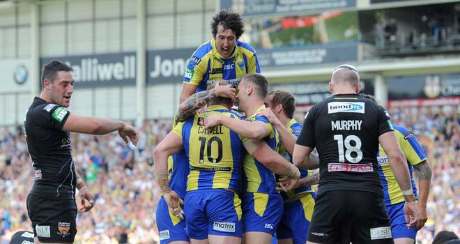 Warrington players celebrate a try against Huddersfield