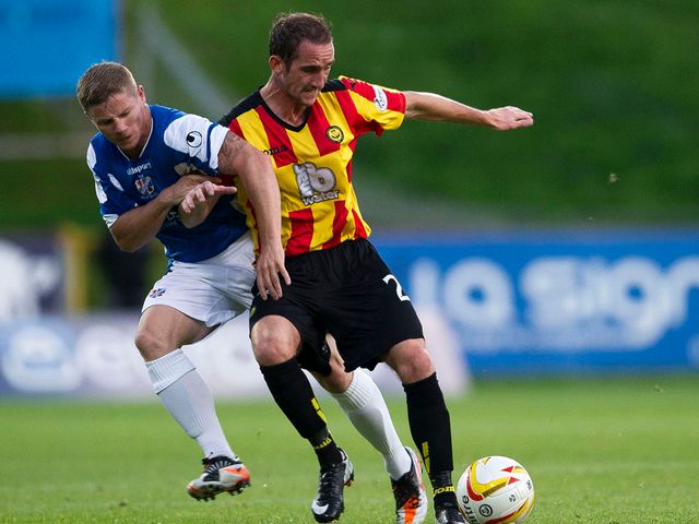 Marc McKenzie battles for the ball with Partick's Mark Kerr