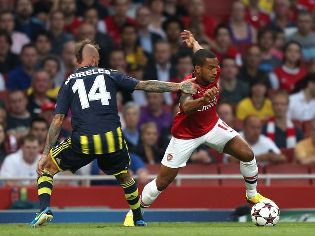 Theo Walcott gets past Fenerbache's Raul Meireles