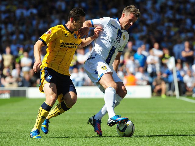 Andrew Crofts and Michael Tonge battle for the ball.