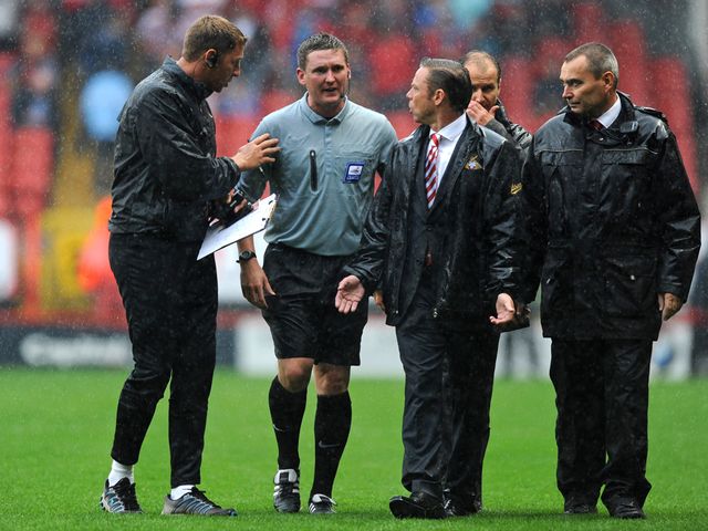 Doncaster boss Paul Dickov talks to the referee.
