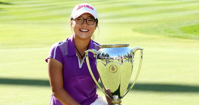 Lydia Ko poses with her second Canadian Open trophy in August