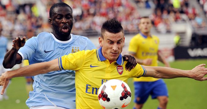 Laurent Koscielny shields the ball from Yaya Toure in Helsinki