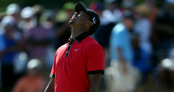 Tiger Woods reacts after missing a putt on the 12th hole during the final round of The Barclays