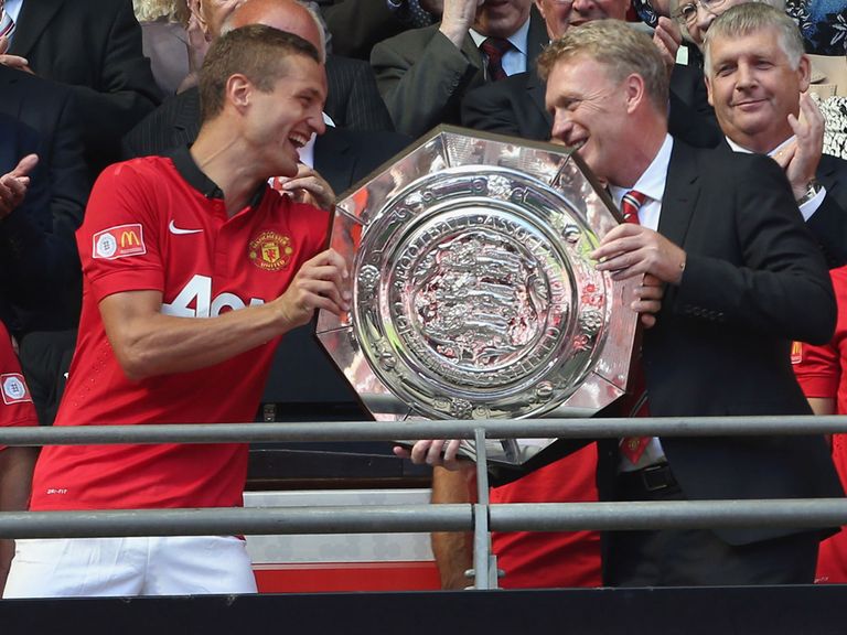 Nemanja Vidic hands the Community Shield to David Moyes.