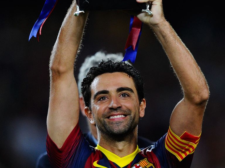 Xavi Hernandez holds the trophy aloft