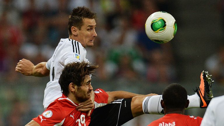 Miroslav Klose wins an aerial battle