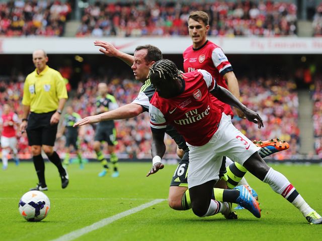 Bacary Sagna and Charlie Adam battle for the ball