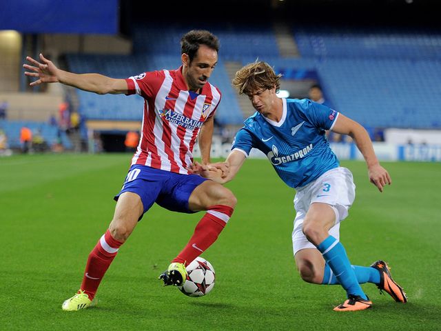 Juanfran and Cristian Ansaldi compete for possession
