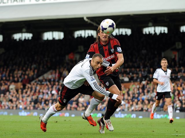 Dimitar Berbatov and Jonas Olsson battle for possession