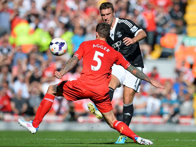 Rickie Lambert knocks the ball away from Daniel Agger.