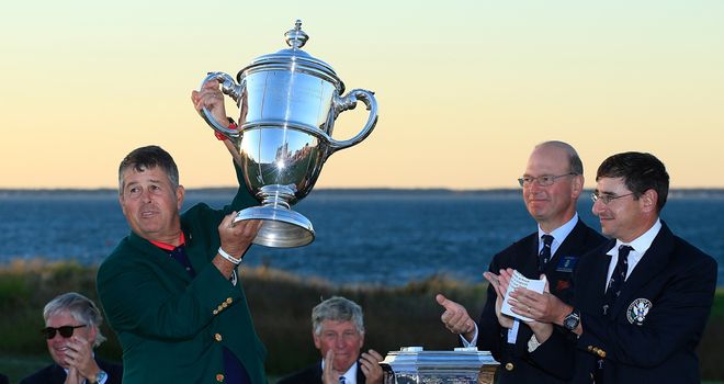 Victorious US captain Jim Holtgrieve holds the Walker Cup aloft